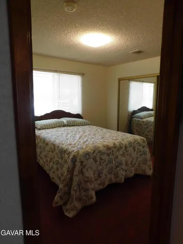 a bedroom with a bed and a mirror