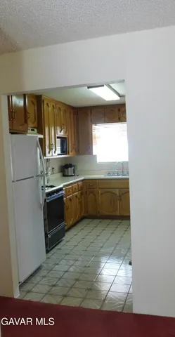 a kitchen with a refrigerator and a sink