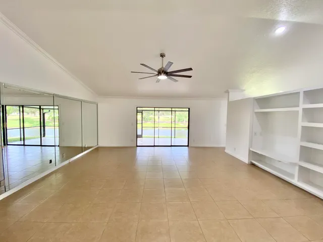 a view of an empty room with a floor to ceiling window near an ocean view