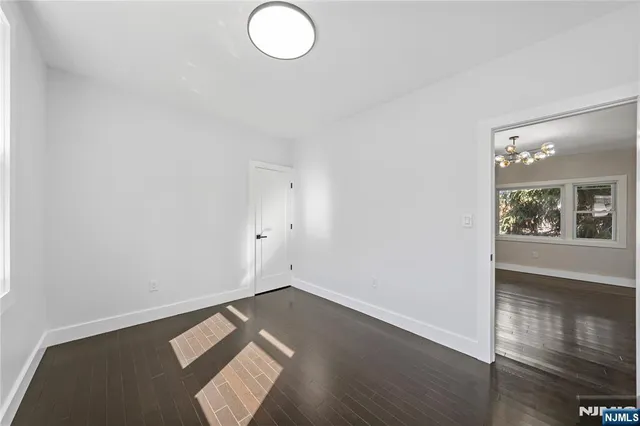 an empty room with wooden floor