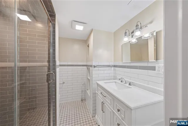 a bathroom with a sink double vanity and a mirror