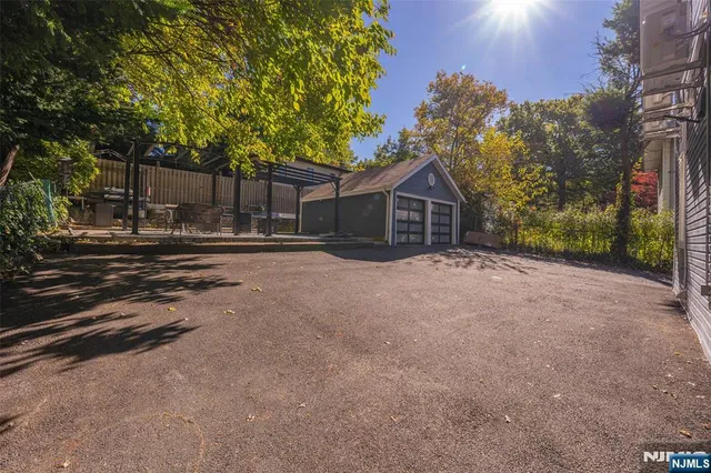 a view of a house with a tree in the background