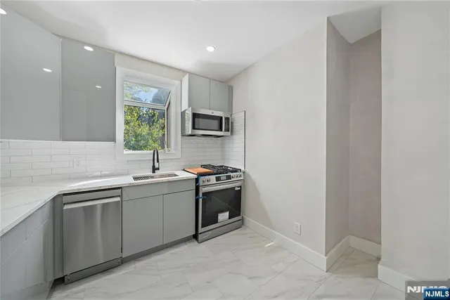a kitchen with a sink and a stove top oven