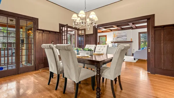 a view of a dining room with furniture wooden floor and chandelier