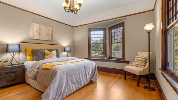 a bedroom with a bed and a chair