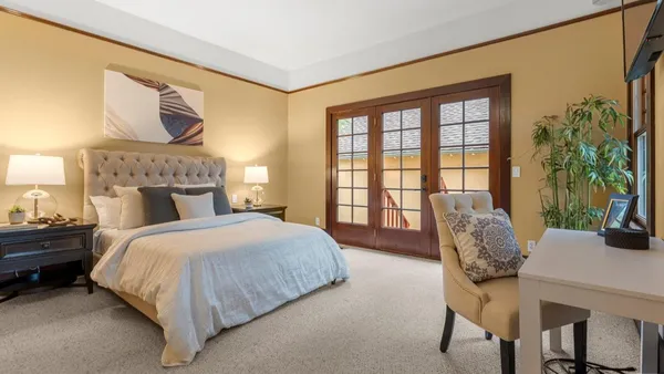 a bed room with a bed and a chair