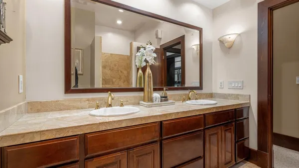 a bathroom with a granite countertop sink and a mirror
