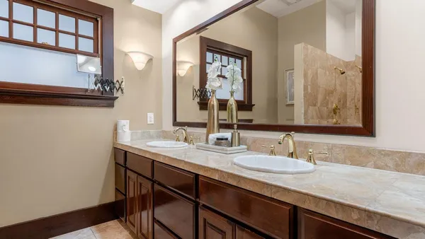 a bathroom with a granite countertop sink a large mirror and a