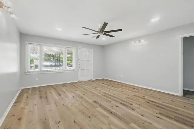 wooden floor in an empty room with a window