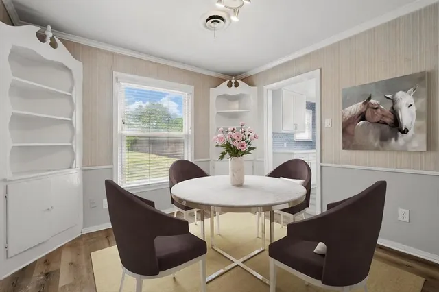 a dining room with furniture and window