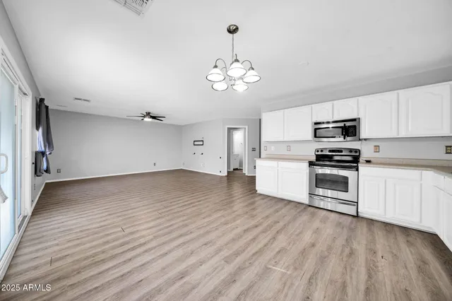 a view of an entryway with wooden floor