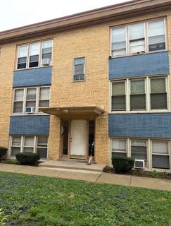 front view of a brick house with a yard