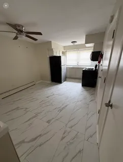 a kitchen with stainless steel appliances granite countertop a refrigerator and a stove