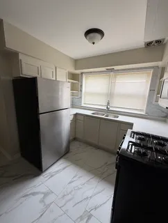 a kitchen with stainless steel appliances granite countertop a sink and a stove