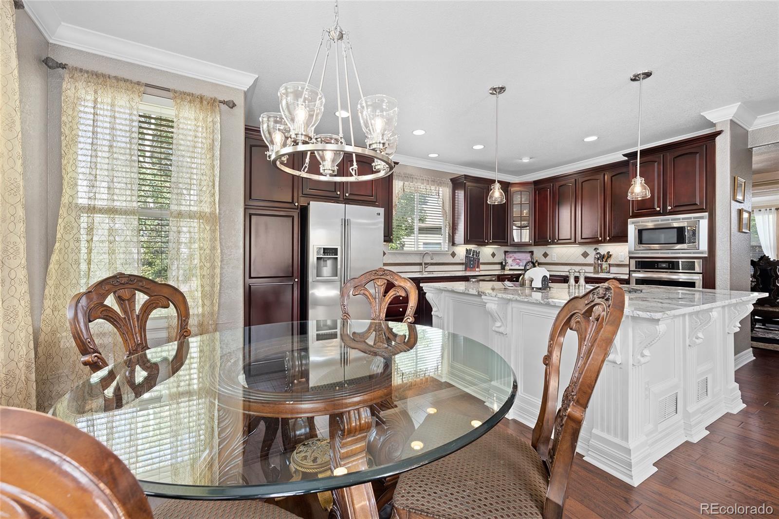 6374 Umber Circle Arvada, CO 80403 - Photo 12 of 33 a view of a dining room with furniture
