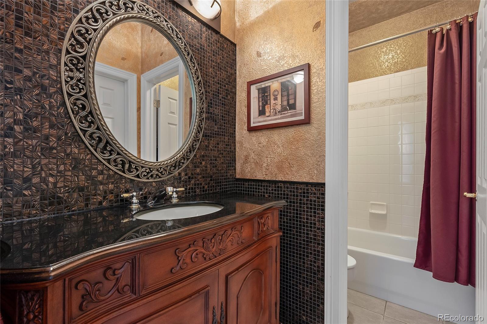 6374 Umber Circle Arvada, CO 80403 - Photo 14 of 33 a bathroom with a sink and a mirror