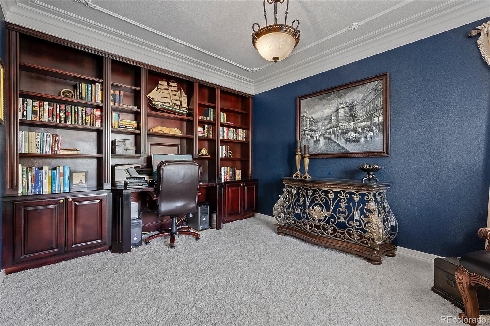 6374 Umber Circle Arvada, CO 80403 - Photo 15 of 33 a bedroom with furniture and a book shelf