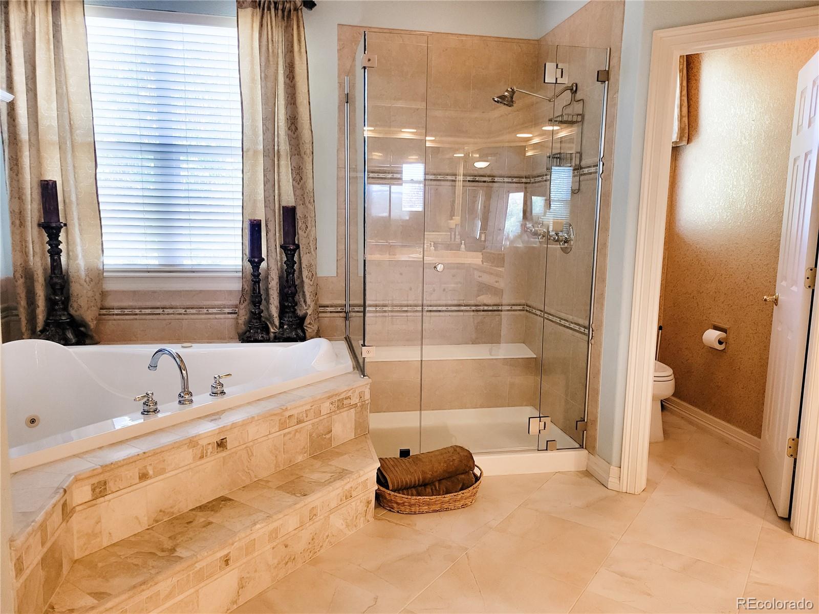 6374 Umber Circle Arvada, CO 80403 - Photo 18 of 33 a bathroom with a tub and a shower