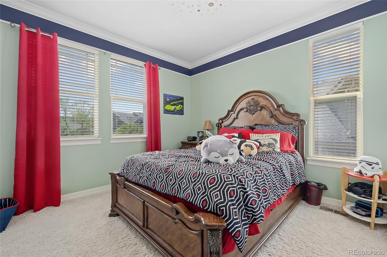 6374 Umber Circle Arvada, CO 80403 - Photo 21 of 33 a bed sitting in a bedroom next to a window