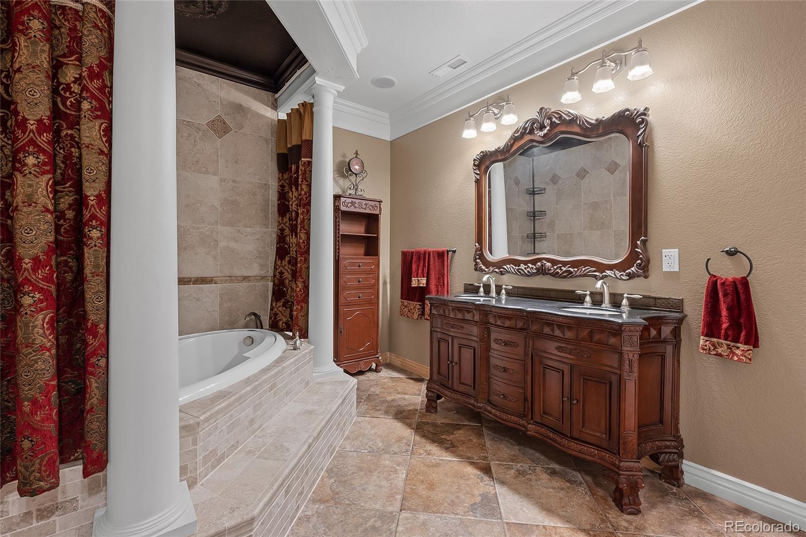 6374 Umber Circle Arvada, CO 80403 - Photo 31 of 33 a bathroom with a bathtub sink and mirror