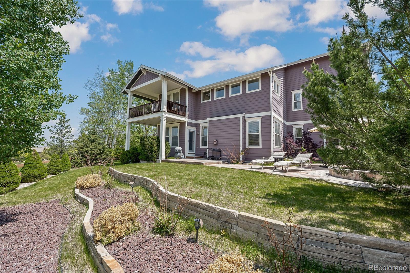 6374 Umber Circle Arvada, CO 80403 - Photo 32 of 33 a front view of a house with a yard table and chairs