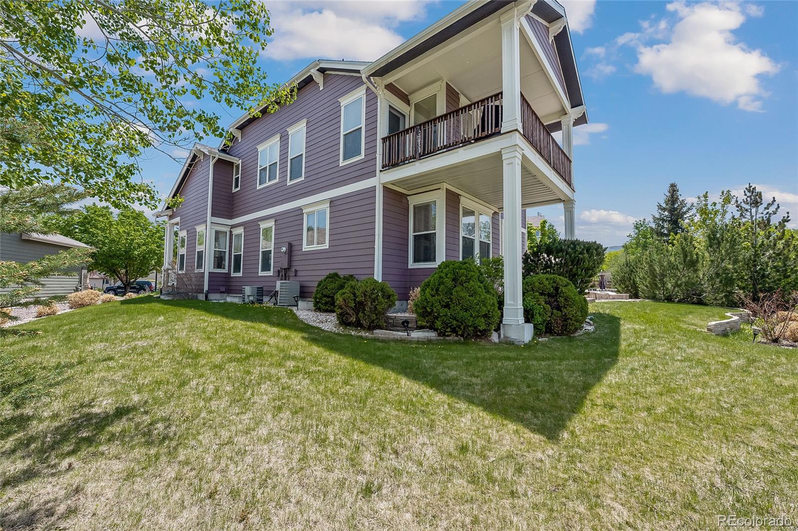6374 Umber Circle Arvada, CO 80403 - Photo 33 of 33 a view of a big building with big yard and large trees