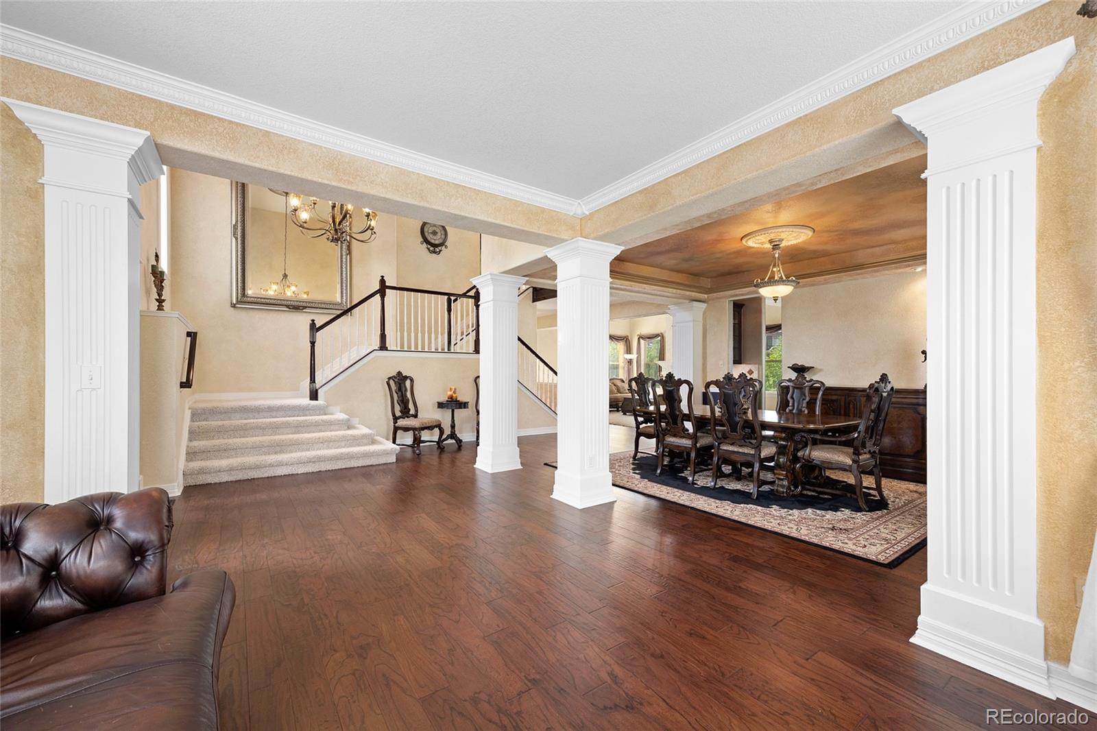 6374 Umber Circle Arvada, CO 80403 - Photo 5 of 33 a living room with furniture wooden floor and a large window