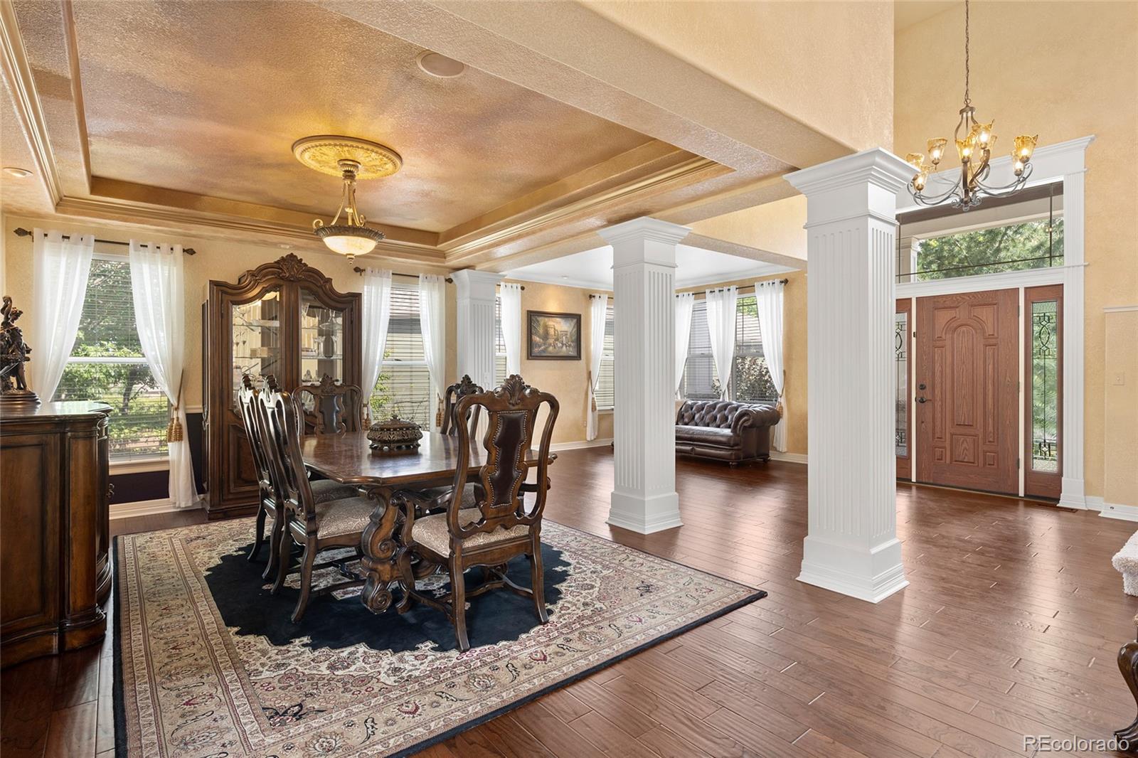 6374 Umber Circle Arvada, CO 80403 - Photo 6 of 33 a view of a dining room with furniture wooden floor and chandelier