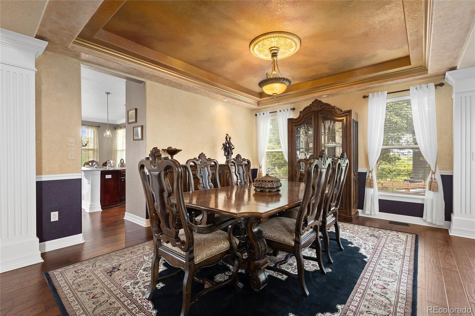 6374 Umber Circle Arvada, CO 80403 - Photo 7 of 33 a view of a dining room with furniture window and wooden floor