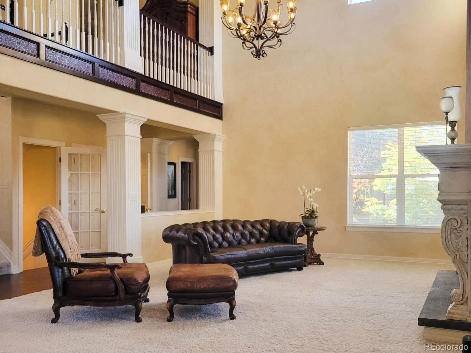 6374 Umber Circle Arvada, CO 80403 - Photo 10 of 33 a living room with furniture a fireplace and a large window