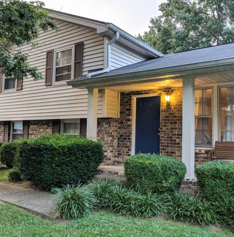 a view of a house with a small yard and plants