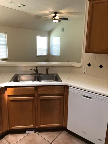 a utility room with sink and washer