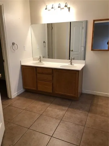 a bathroom with a sink vanity and a mirror