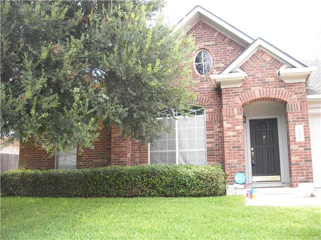 7600 Amanda Ellis Way Austin, TX 78749 - Photo 2 of 22 a front view of a house with a garden