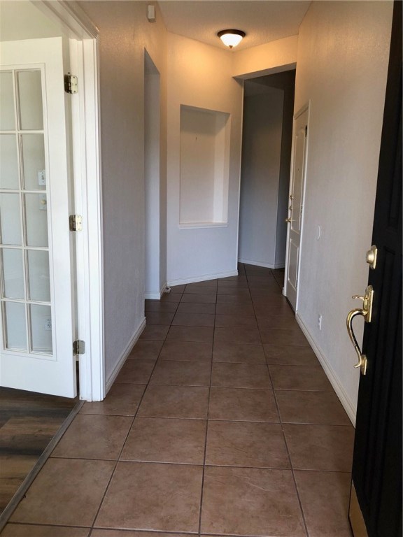 7600 Amanda Ellis Way Austin, TX 78749 - Photo 3 of 22 a view of a hallway to rooms