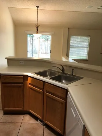a kitchen with a sink and cabinets