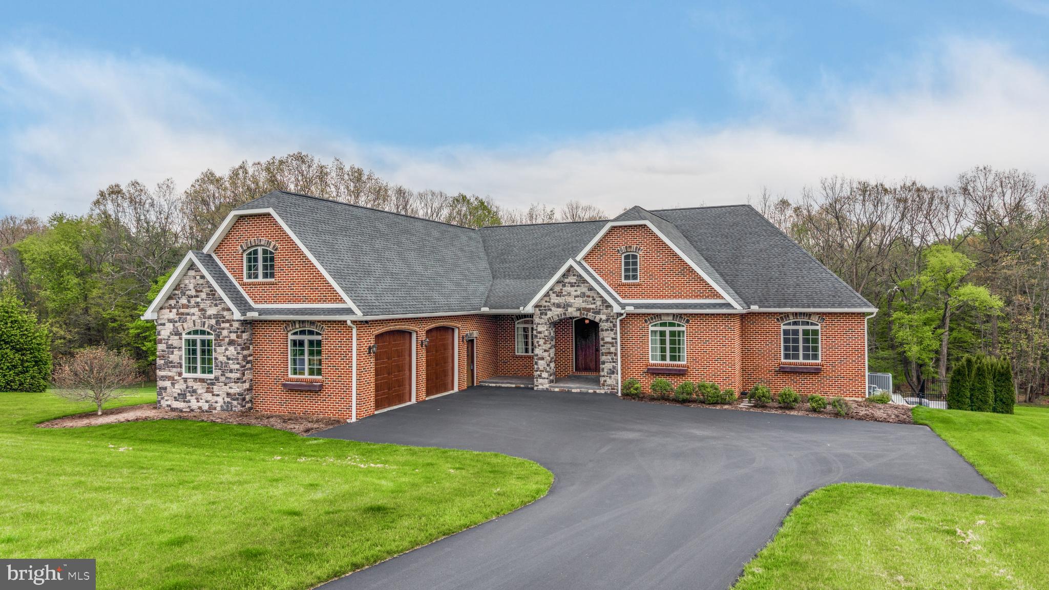 an aerial view of a house next to a big yard
