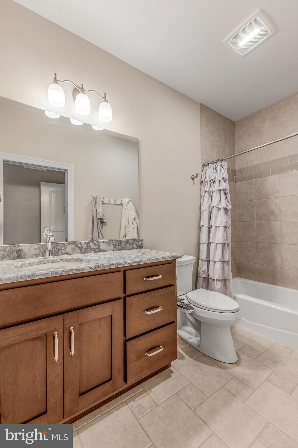 156 Brothers Court Port Matilda, PA 16870 - Photo 60 of 98 a bathroom with a granite countertop sink a toilet and a mirror