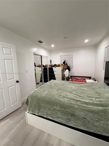 a bed room with a bed and two room