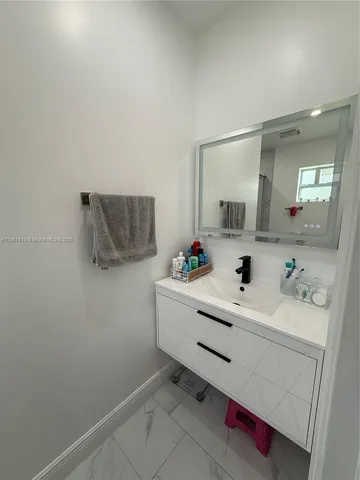 a utility room with sink dryer and washer