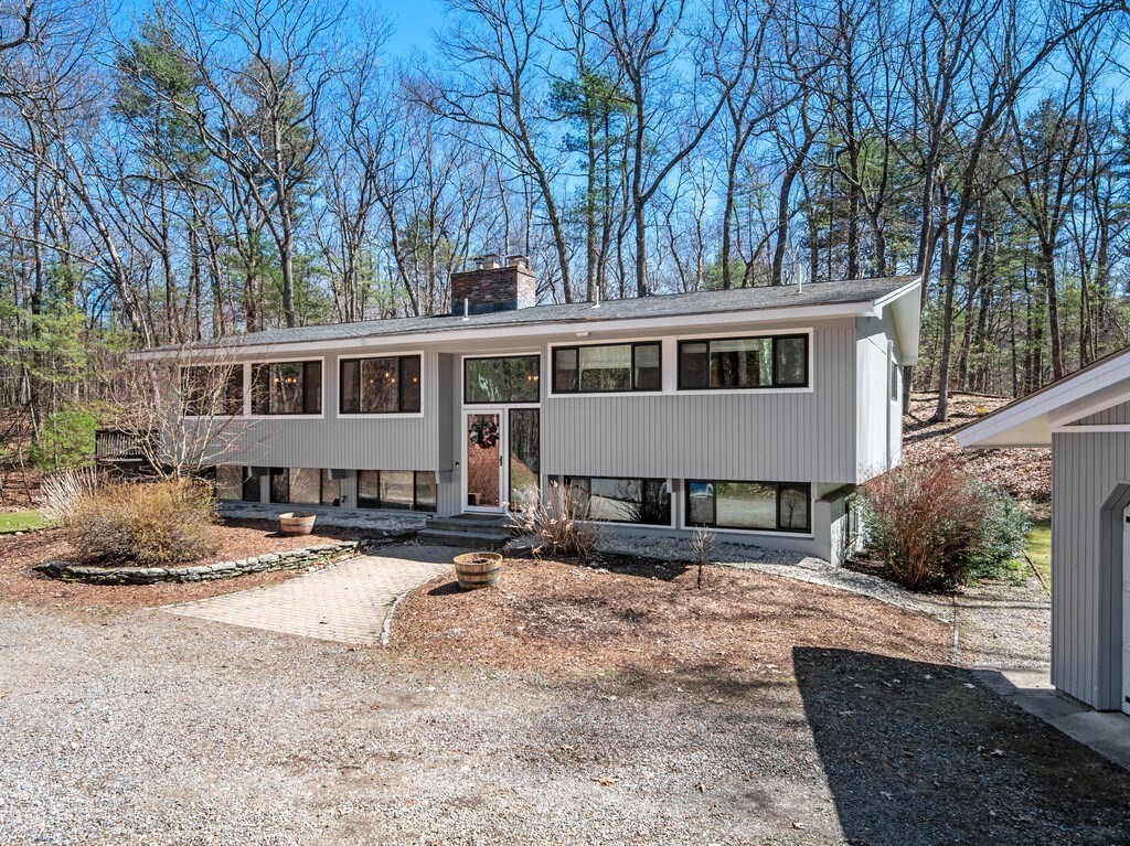 552 Lowell Road Groton, MA 01450 - Photo 1 of 42 a front view of a house with a yard