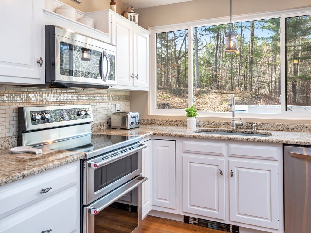 552 Lowell Road Groton, MA 01450 - Photo 11 of 42 a kitchen with granite countertop cabinets stainless steel appliances and a sink