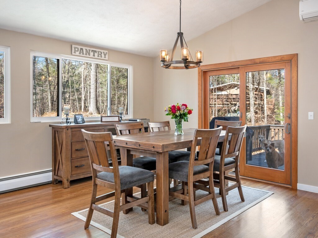 552 Lowell Road Groton, MA 01450 - Photo 14 of 42 a view of a dining room with furniture window and wooden floor