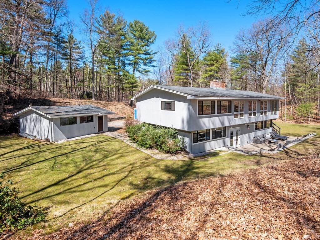 552 Lowell Road Groton, MA 01450 - Photo 2 of 42 a view of a house with a patio and a yard