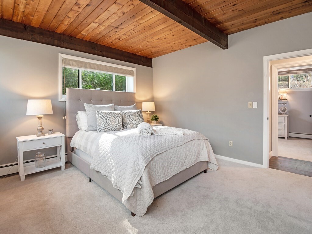 552 Lowell Road Groton, MA 01450 - Photo 30 of 42 a bed room with a bed and a lamp