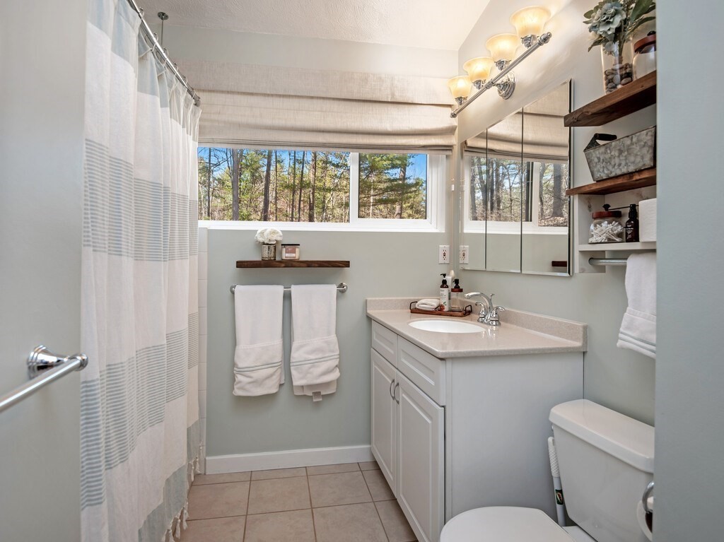 552 Lowell Road Groton, MA 01450 - Photo 34 of 42 a bathroom with a sink toilet and window