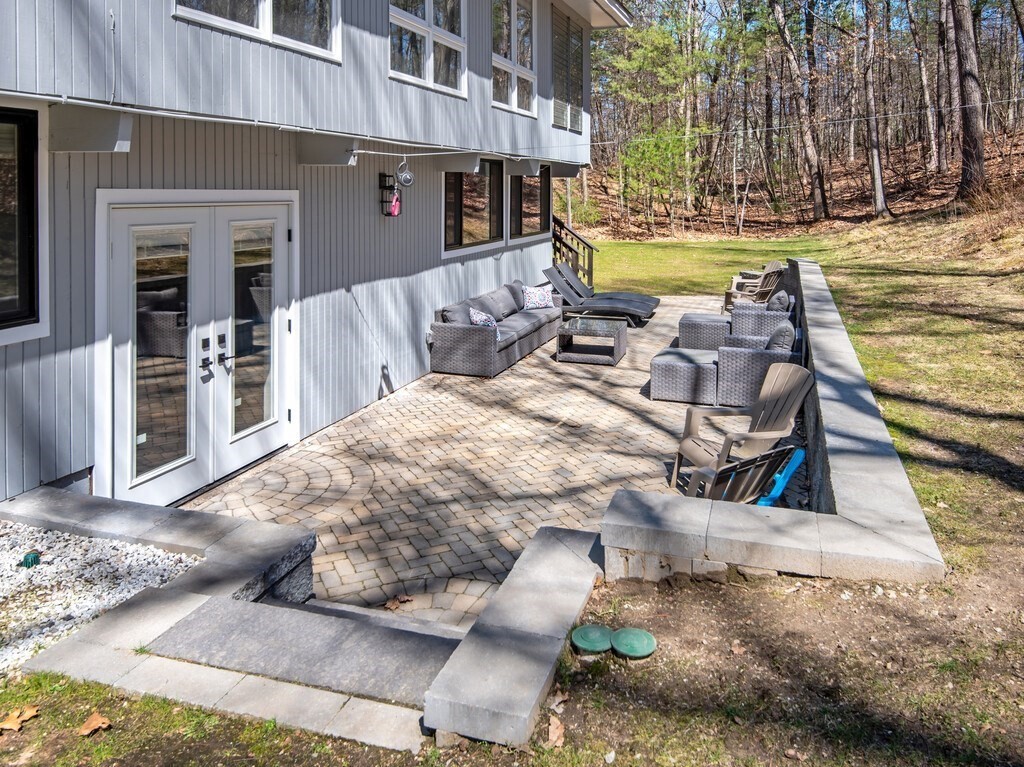 552 Lowell Road Groton, MA 01450 - Photo 36 of 42 a view of a swimming pool with outdoor seating