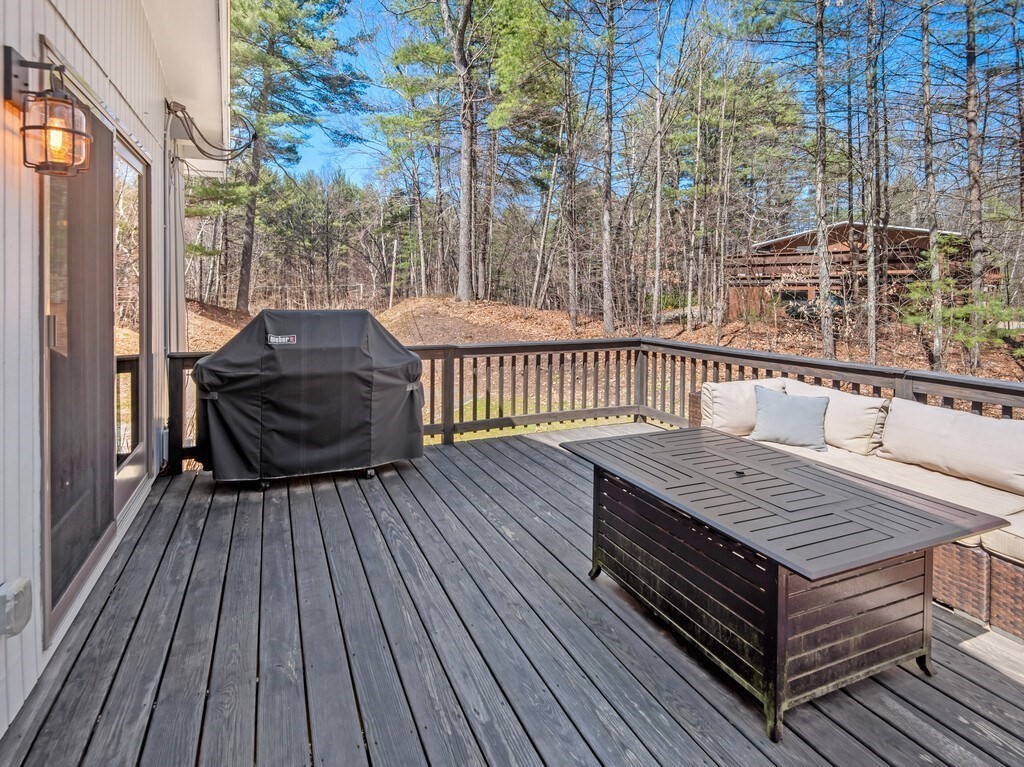 552 Lowell Road Groton, MA 01450 - Photo 39 of 42 a view of a wooden deck with a bench