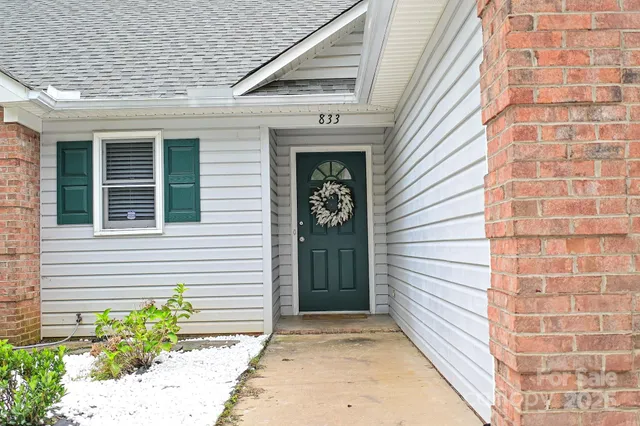 a view of a brick house with potted plants