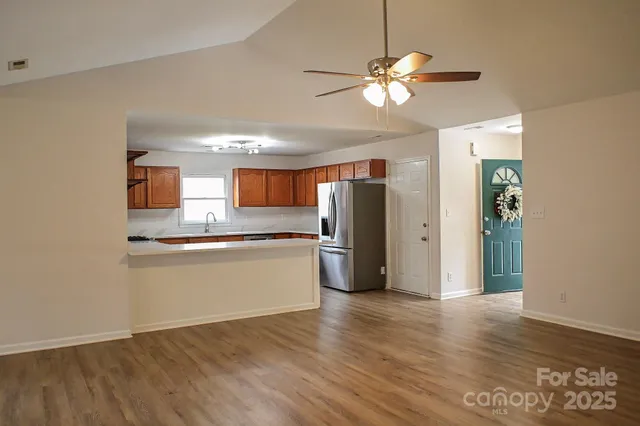 a kitchen with stainless steel appliances granite countertop a refrigerator and a sink
